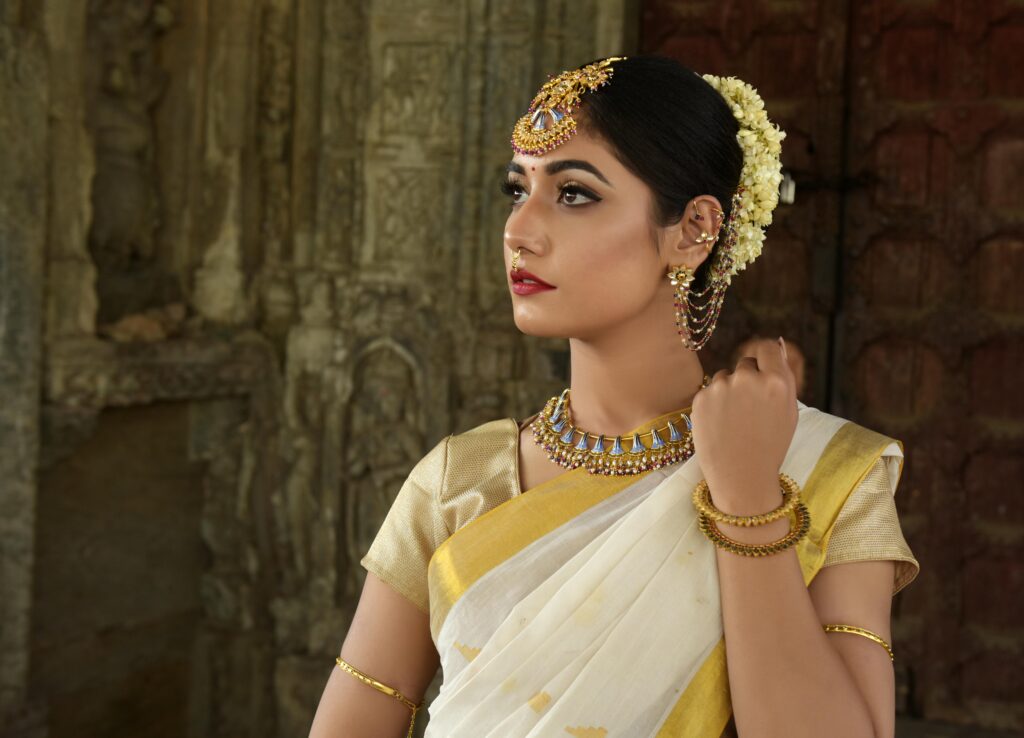 Bridal makeup Beautiful Indian woman in traditional saree, adorned with exquisite jewelry.